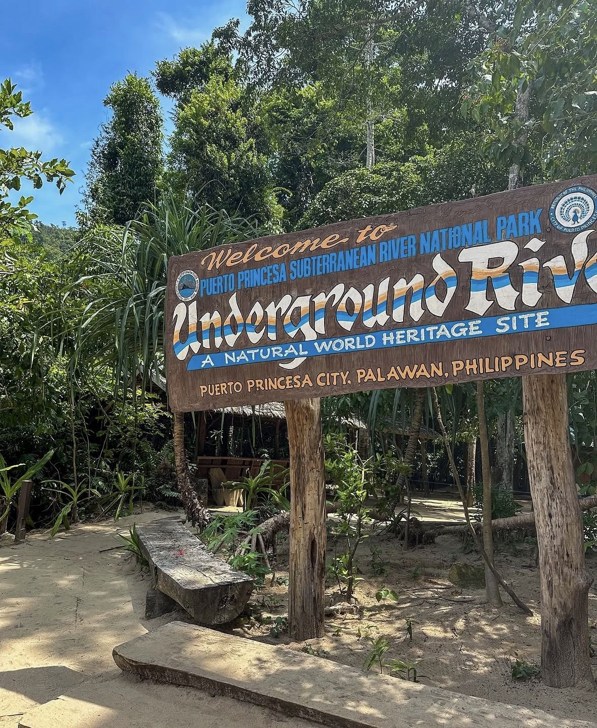 Tourists wearing helmets and life vests on a guided cave boat tour for safety inside the underground river